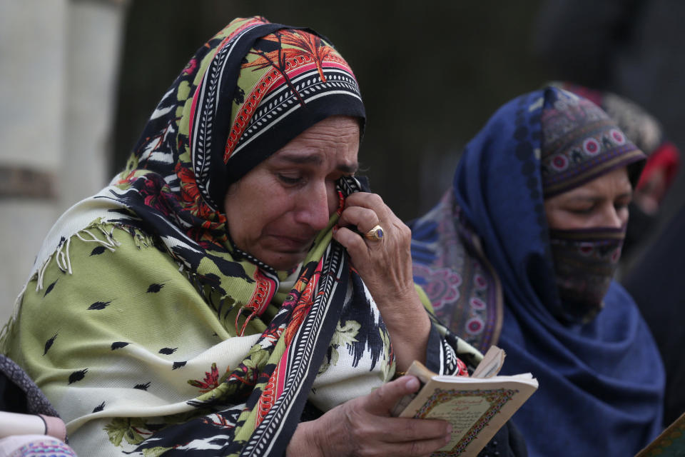 Women weep as they recite verses from the Quran during a prayer ceremony for victims of Monday's suicide bombing inside a mosque, in Peshawar, Pakistan, Wednesday, Feb. 1, 2023. (AP Photo/Muhammad Sajjad)