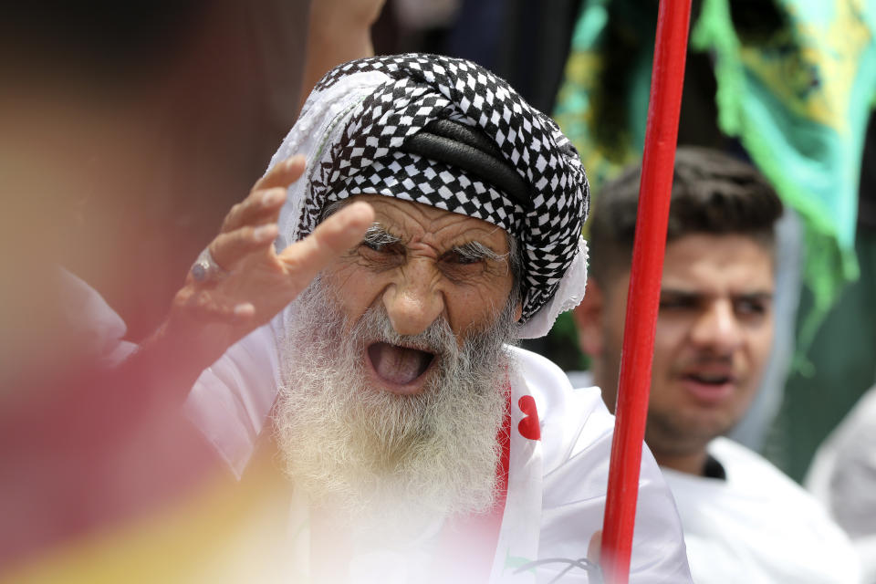 A man chants slogans during an open-air Friday prayers in Sadr City, Baghdad, Iraq, Friday, July 15, 2022. (AP Photo/Hadi Mizban)