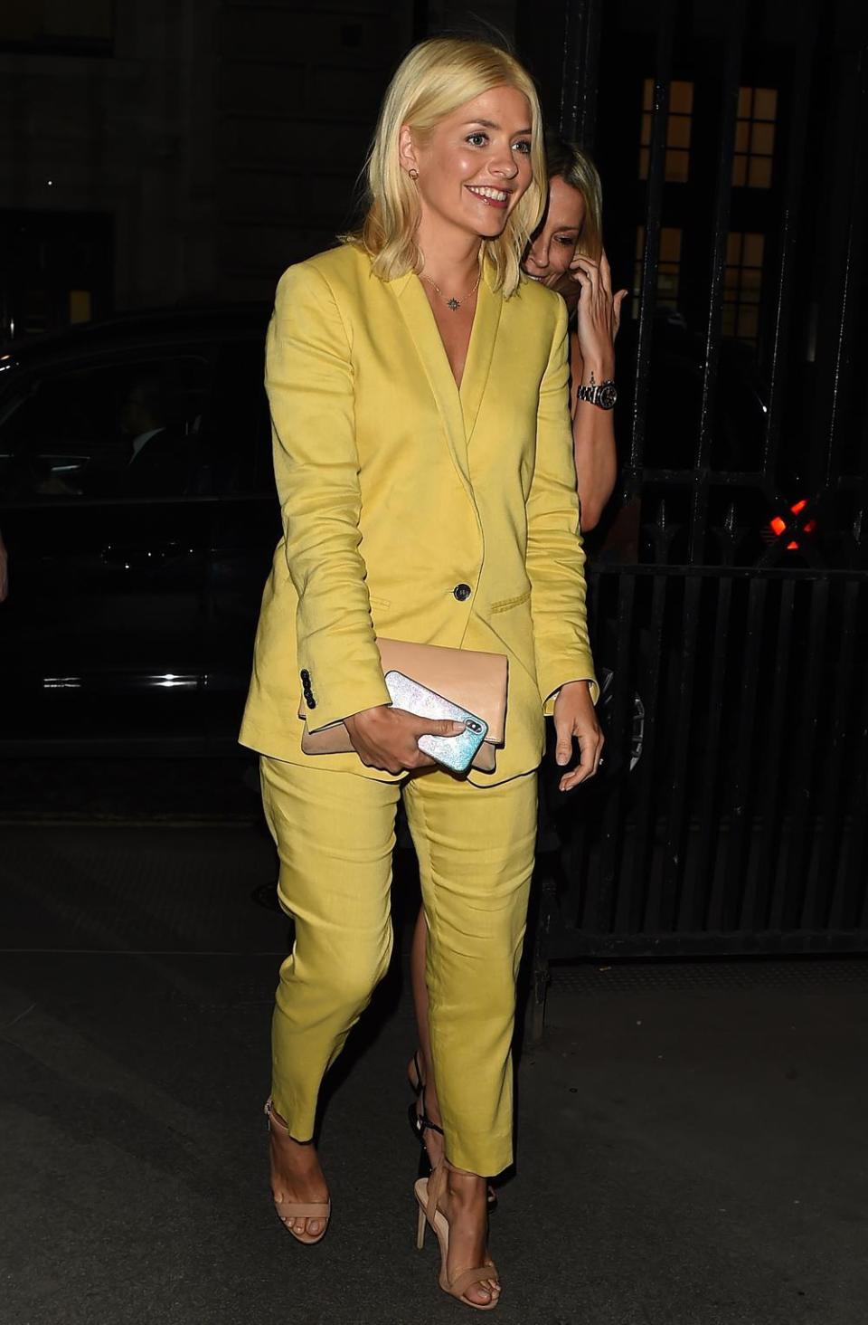 Sunshine: Holly Willoughby stunned in a yellow trouser suit (Splash News)