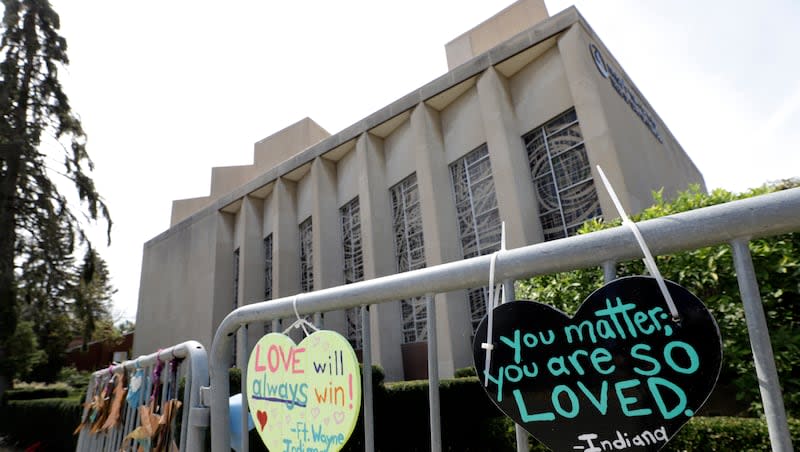 Signs hang on a fence surrounding the Tree of Life synagogue in Pittsburgh on Sept. 17, 2019.