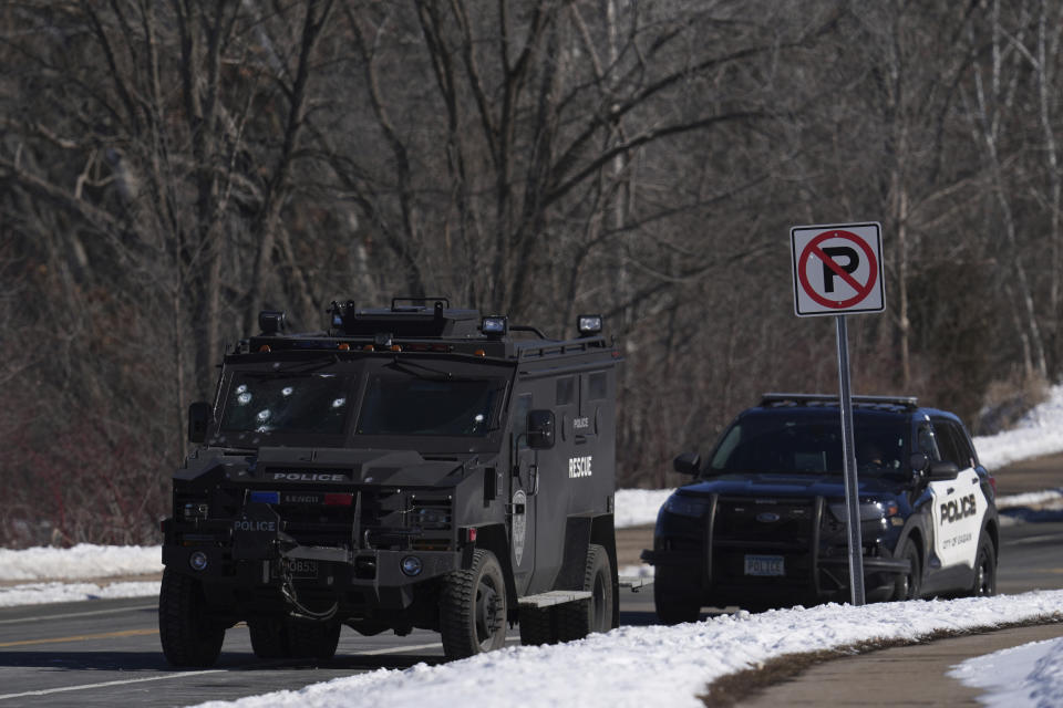 A police vehicle with what appears to be bullet pockmarks on its windshield is parked near the scene where two police officers and a first responder were shot and killed Sunday, Feb. 18, 2024, in Burnsville, Minn. (AP Photo/Abbie Parr)