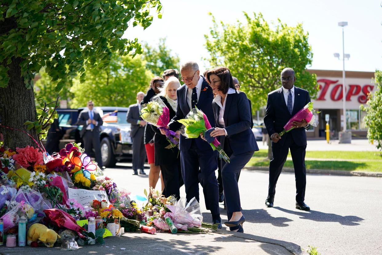 (front to back) New York Gov. Kathy Hochul, Senate Majority Leader Chuck Schumer (D-N.Y.), and Sen. Kirsten Gillibrand (D-N.Y.) place flowers at a memorial at the scene of a shooting at a supermarket as they pay respects to the victims of shooting in Buffalo, N.Y. on May 17, 2022. 