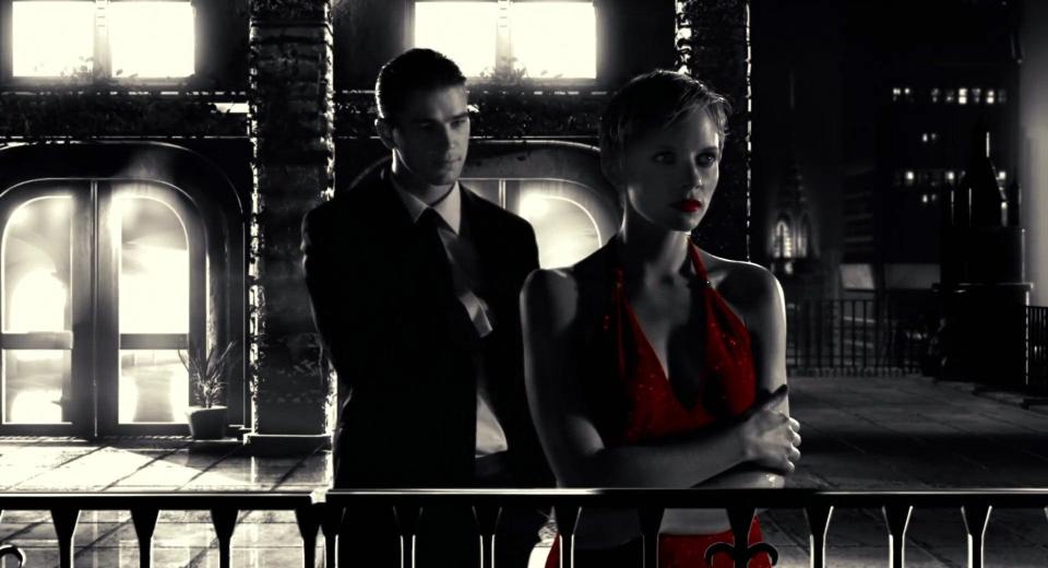 Josh Hartnett in a suit standing next to Marley Shelton in a red dress