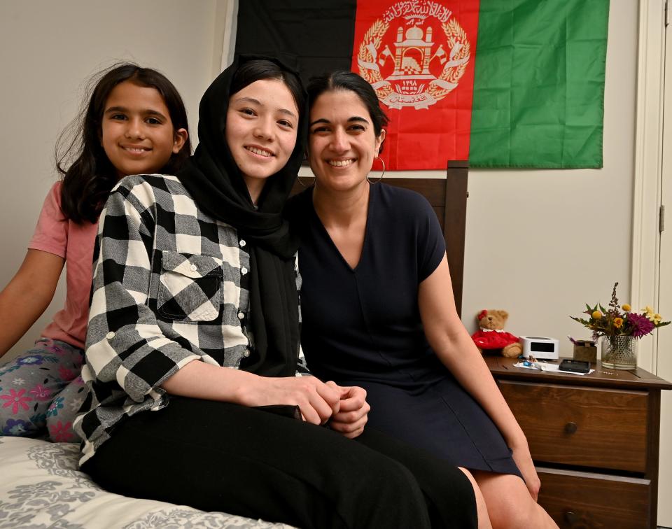 Kubra Mohammadi, center, a junior at Shrewsbury High School, in her bedroom with her foster mother Sanam Zaer and foster sister Kimia Zaer, 8.