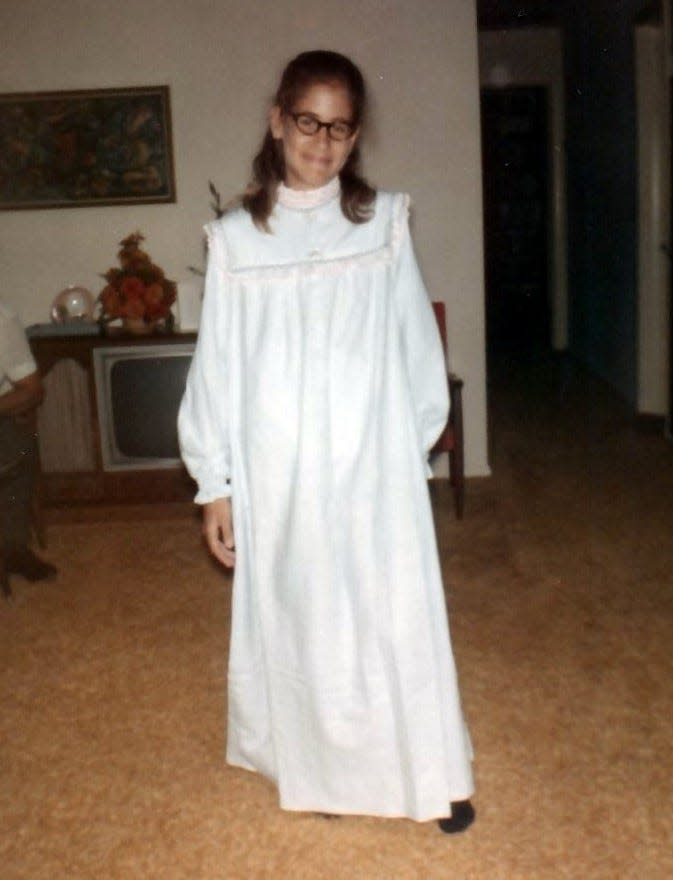 A young Janet Meckstroth wears a nightgown made for her by her mother.