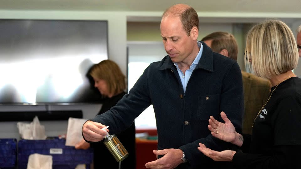 The prince is shown items by charity operations director Claire Hopkins during the engagement at the surplus food redistribution charity. - Alastair Grant/Reuters