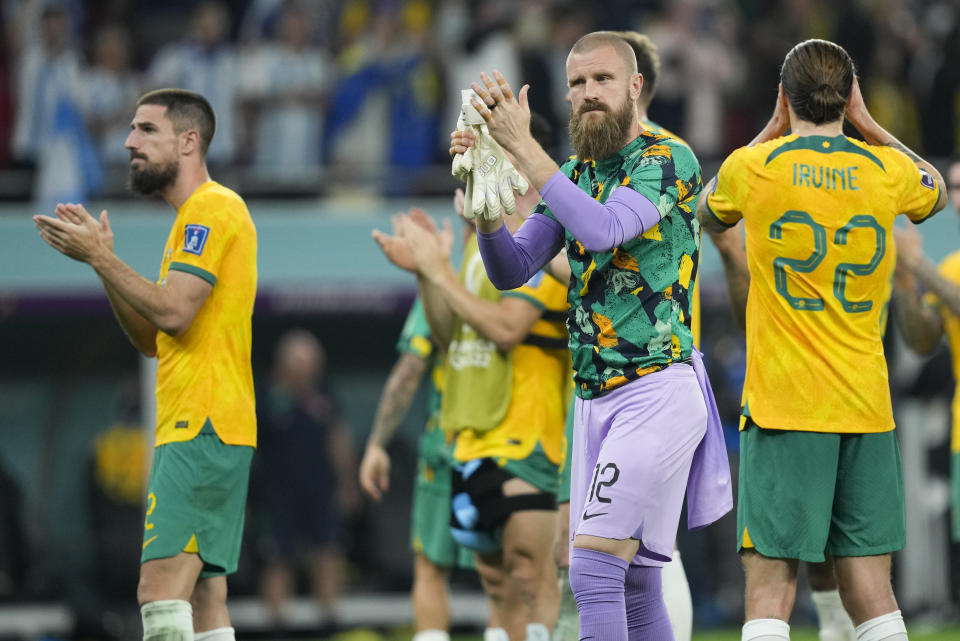 Australian players react to supporters following the World Cup round of 16 soccer match against Argentina at the Ahmad Bin Ali Stadium in Doha, Qatar, Sunday, Dec. 4, 2022. (AP Photo/Jorge Saenz)