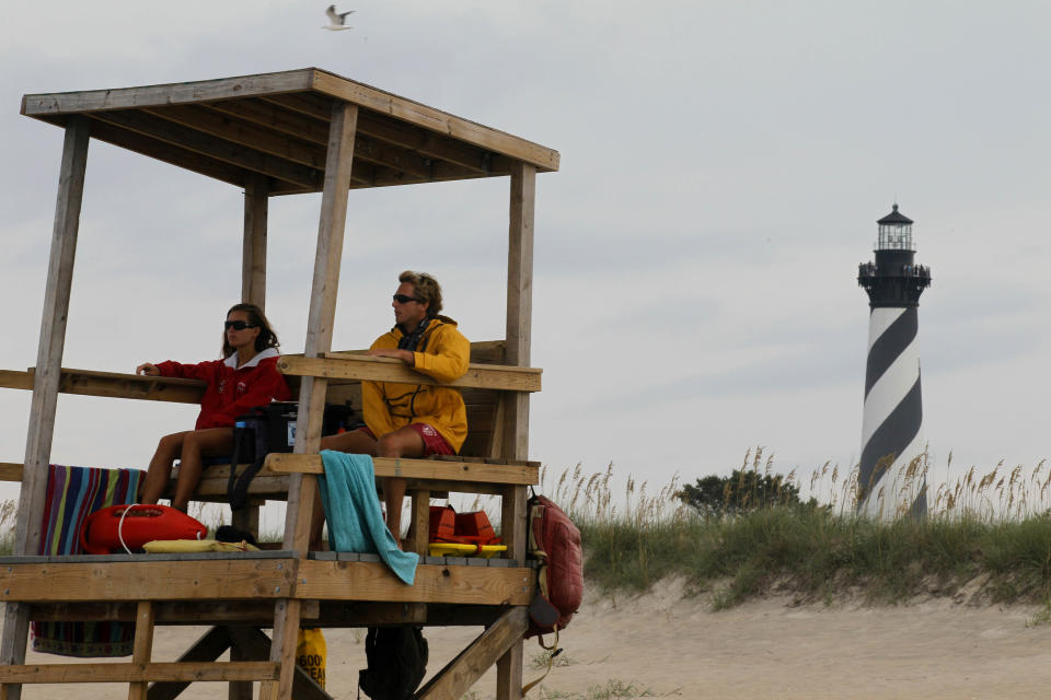 FILE - In this Aug. 24, 2011 file photo, lifeguards keep watch over the beach along the Cape Hatteras National Seashore in Buxton, N.C. Cape Hatteras is number eight on the 2013 list of Top 10 Beaches produced annually by coastal expert Stephen P. Leatherman, also known as "Dr. Beach," director of Florida International University's Laboratory for Coastal Research. (AP Photo/Gerry Broome, file)