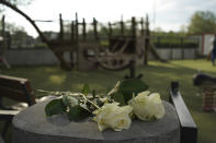 Roses lay at the playground after a knife attack Thursday, June 8, 2023 in Annecy, French Alps. A a man with a knife stabbed four young children at a lakeside park in the French Alps on Thursday, assaulting at least one in a stroller repeatedly. The children between 22 months and 3 years old suffered life-threatening injuries, and two adults also were wounded, authorities said. (AP Photo/Laurent Cipriani)