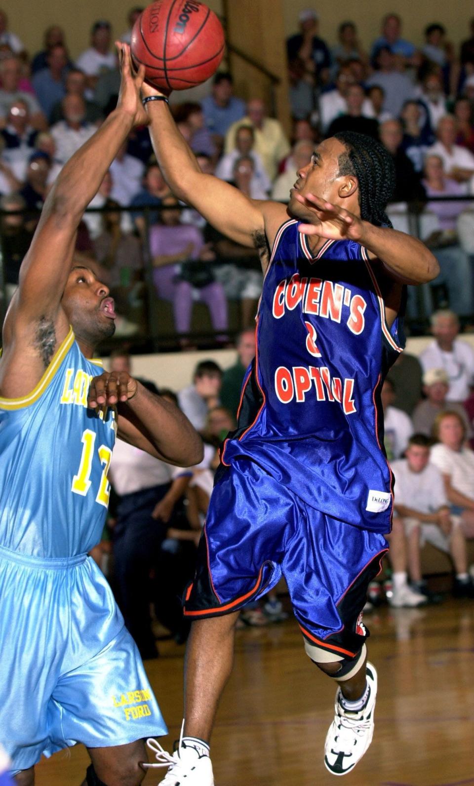 Larson Ford's Marvin Andrews, the former Lakewood star who led Saint Peter's to its first NCAA Tournament appearance in 1991, tries to stop Cohen's Optical's Shaheen Holloway, the current Saint Peter's coach who has led his team to the NCAA Tournament's Sweet 16, in the 2004 Jersey Shore Basketball League championship game at St. Rose High School.