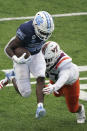 Virginia Tech linebacker Rayshard Ashby chases North Carolina running back Javonte Williams (25) during the first half of an NCAA college football game in Chapel Hill, N.C., Saturday, Oct. 10, 2020. (AP Photo/Gerry Broome)