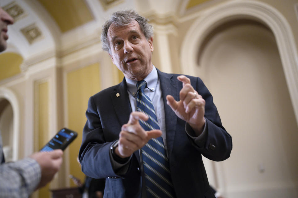 FILE - Senate Banking Committee Chairman Sherrod Brown, D-Ohio, takes questions from reporters outside the chamber during votes, at the Capitol in Washington, March 15, 2023. (AP Photo/J. Scott Applewhite, File)