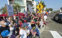 Protesters against the escalating conflict between Armenia and neighboring Azerbaijan hold signs and flags along President Trump's motorcade route to a fundraiser in Newport Beach, Calif., Sunday, Oct. 18, 2020. (Leorard Ortiz/The Orange County Register via AP)