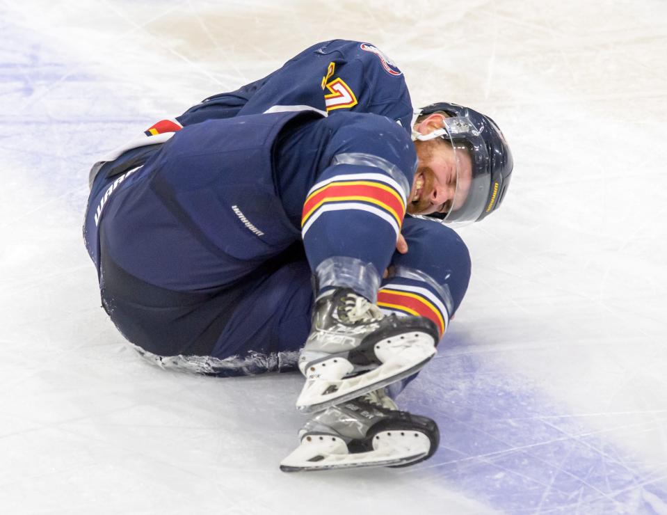 Peoria's Alec Hagaman curls up in pain after colliding with a Roanoke player in the third period of Game 3 of the SPHL semifinals Sunday, April 23, 2023 at Carver Arena.