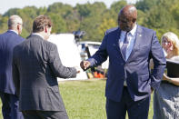 United Auto Workers President Ray Curry, right, bumps fists with Jim Farley, Ford president and CEO, left, after a presentation on the planned factory to build electric F-Series trucks and the batteries to power future electric Ford and Lincoln vehicles Tuesday, Sept. 28, 2021, in Memphis, Tenn. The plant in Tennessee is to be built near Stanton, Tenn. (AP Photo/Mark Humphrey)