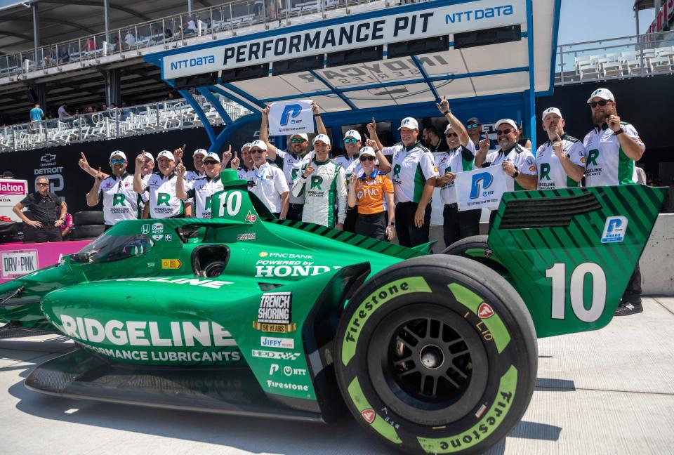 Alex Palou (10) stands with his crew after receiving the NTT P1 Award during the NTT IndyCar Series qualifying at the Detroit Grand Prix in Detroit on Saturday, June 3, 2023. 