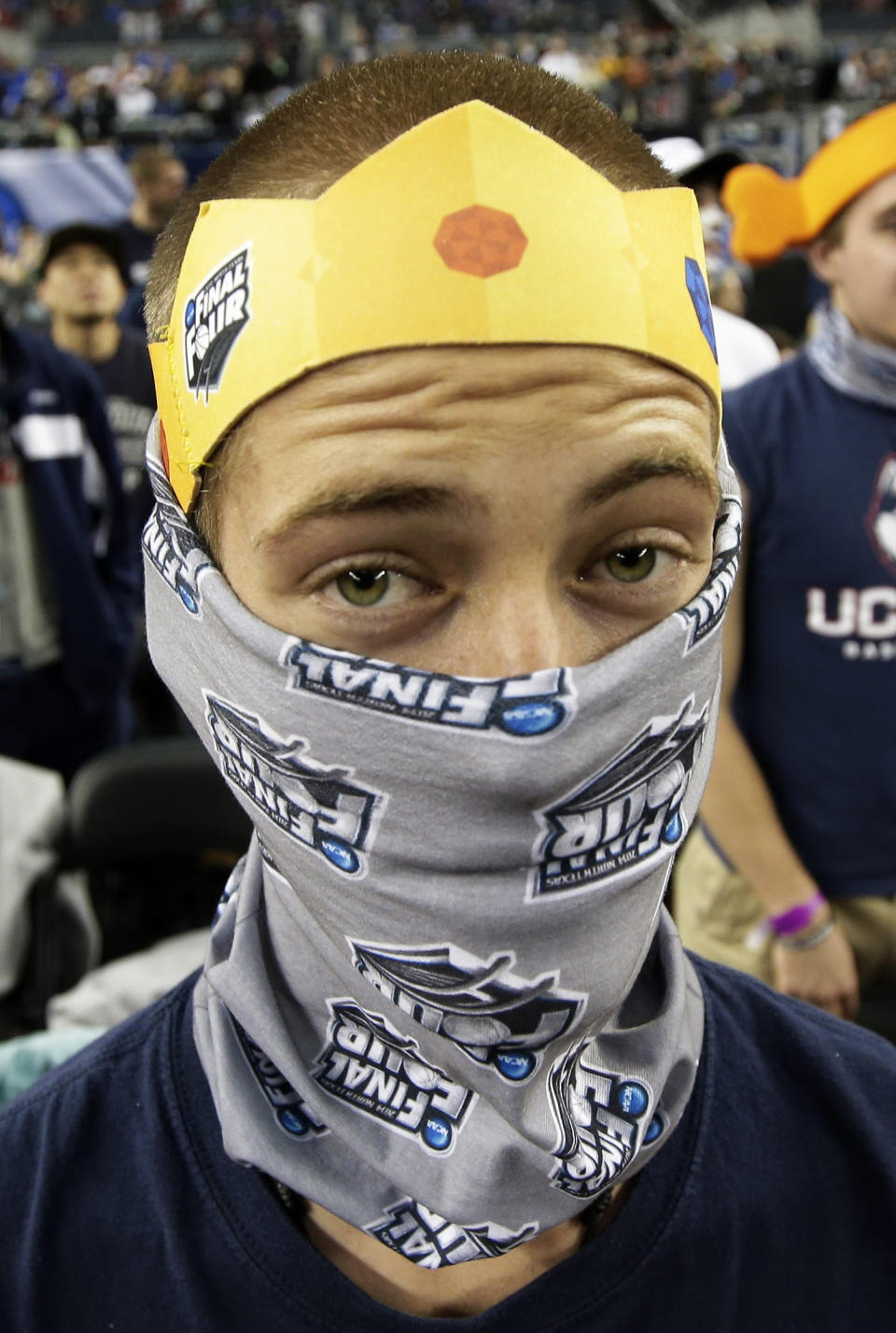 A Connecticut fan is dressed in team colors before the NCAA Final Four tournament college basketball semifinal game against Florida Saturday, April 5, 2014, in Arlington, Texas. (AP Photo/Tony Gutierrez)