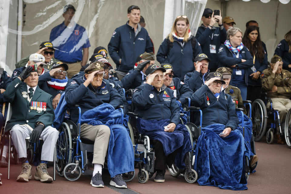 U.S. war veterans salute during a ceremony to mark the 79th anniversary of the assault that led to the liberation of France and Western Europe from Nazi control, at the American Cemetery in Colleville-sur-Mer, Normandy, France, Tuesday, June 6, 2023. The American Cemetery is home to the graves of 9,386 United States soldiers. Most of them lost their lives in the D-Day landings and ensuing operations. (AP Photo/Thomas Padilla)