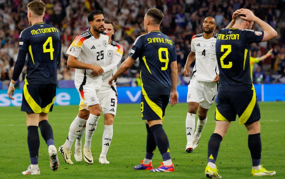 <span>Scott McTominay, Lawrence Shankland and Anthony Ralston react as Emre Can (second left) celebrates scoring <a class="link " href="https://sports.yahoo.com/soccer/teams/germany-women/" data-i13n="sec:content-canvas;subsec:anchor_text;elm:context_link" data-ylk="slk:Germany;sec:content-canvas;subsec:anchor_text;elm:context_link;itc:0">Germany</a>’s fifth goal against Scotland.</span><span>Photograph: Tom Jenkins/The Observer</span>