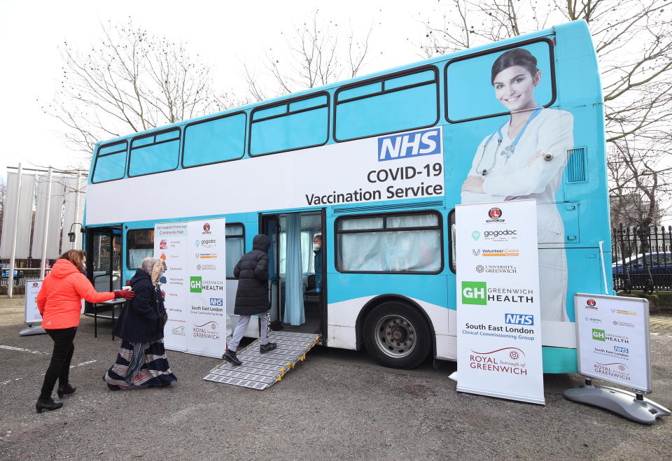 Members of the public receive their Covid-19 vaccinations on board a modified bus - donated by Gogodoc, an on demand GP booking service - in the car park of the University of Greenwich, London. Picture date: Saturday February 13, 2021.