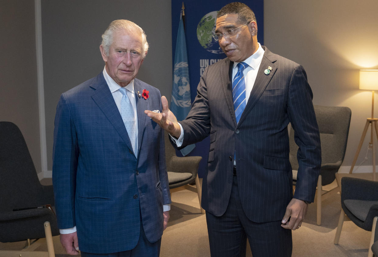 FILE - Britain's Prince Charles, left, greets the Prime Minister of Jamaica Andrew Holness ahead of their bilateral meeting during the Cop26 summit at the Scottish Event Campus (SEC) in Glasgow, Scotland, Tuesday, Nov. 2, 2021. In 2022, when Jamaica’s Prime Minister Andrew Holness welcomed Prince William and his wife, Kate, during a royal tour of the Caribbean, he announced that his country intends to become fully independent. (Jane Barlow/Pool Photo via AP, File)