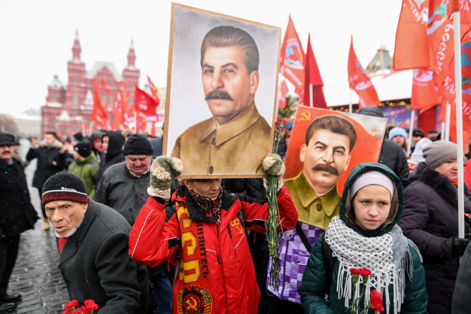 Russian Communist Party supporters hold portraits of Soviet leader Joseph Stalin as they gather in Moscow in 2018.