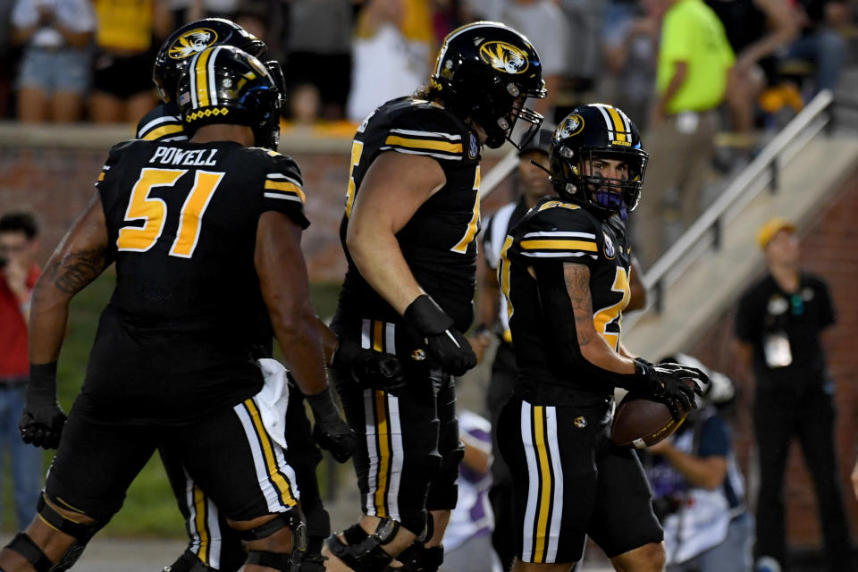 Missouri running back Cody Schrader, right, is congratulated by teammates after scoring on a 5-yard run during the first half of an NCAA college football game against Louisiana Tech Thursday, Sept. 1, in Columbia, Mo. (AP Photo/L.G. Patterson)