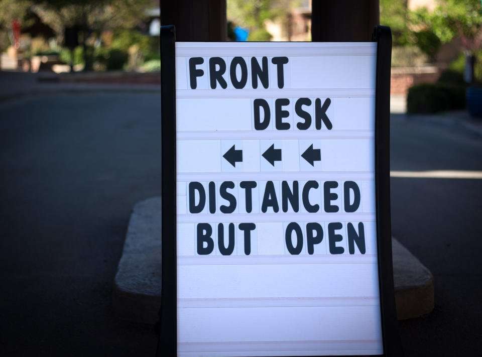 Reopening Sign: FRONT DESK, DISTANCED BUT OPEN