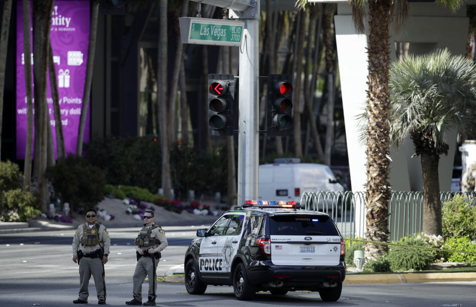 Police officers stand along Las Vegas Boulevard, Saturday, March 25, 2017, in Las Vegas. Police say part of the Strip has been closed down after a shooting. (AP Photo/John Locher)