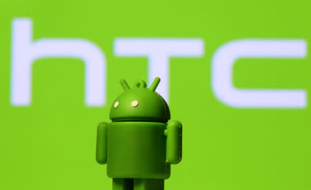 A 3D printed Android mascot Bugdroid is seen in front of an HTC logo in this illustration taken September 21, 2017. REUTERS/Dado Ruvic/Illustration