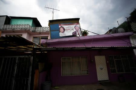 A campaign banner featuring an image of Mexico's presidential election front-runner Andres Manuel Lopez Obrador of the National Regeneration Movement (MORENA) is displayed outside a house before the upcoming July 1 presidential election, in Mexico City, Mexico, June 30, 2018. REUTERS/Daniel Becerril