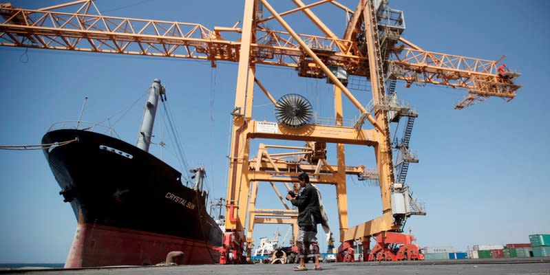 FILE PHOTO - A Houthi militia media officer checks a camera next to giant cranes, damaged by Saudi-led air strikes, at a container terminal at the Red Sea port of Hodeidah, Yemen November 16, 2016.    REUTERS/Khaled Abdullah/File Photo