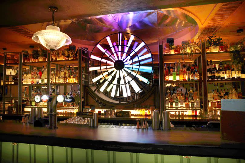 The bar's signature spinning neon wheel is a centrepiece