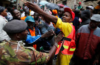 <p>Rescue workers react during the search for residents feared trapped in the rubble of a six-story building that collapsed after days of heavy rain in Nairobi, Kenya, May 1, 2016. <i>(Photo: Thomas Mukoya/Reuters)</i></p>