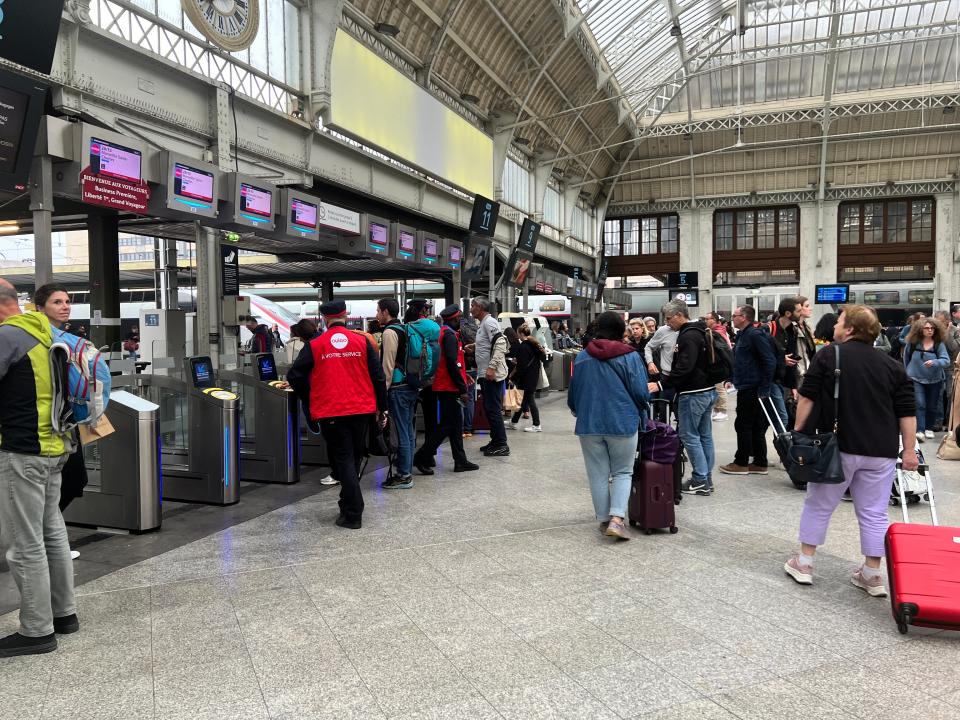 Passengers and a TGV official at Paris Gare de Lyon