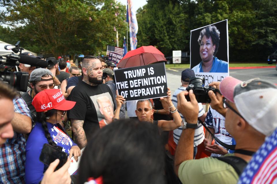 Laurie Arbeiter of Brooklyn, N.Y., and other protesters stand near the Fulton County Jail intake center in Atlanta, GA, on Aug. 24, 2023.