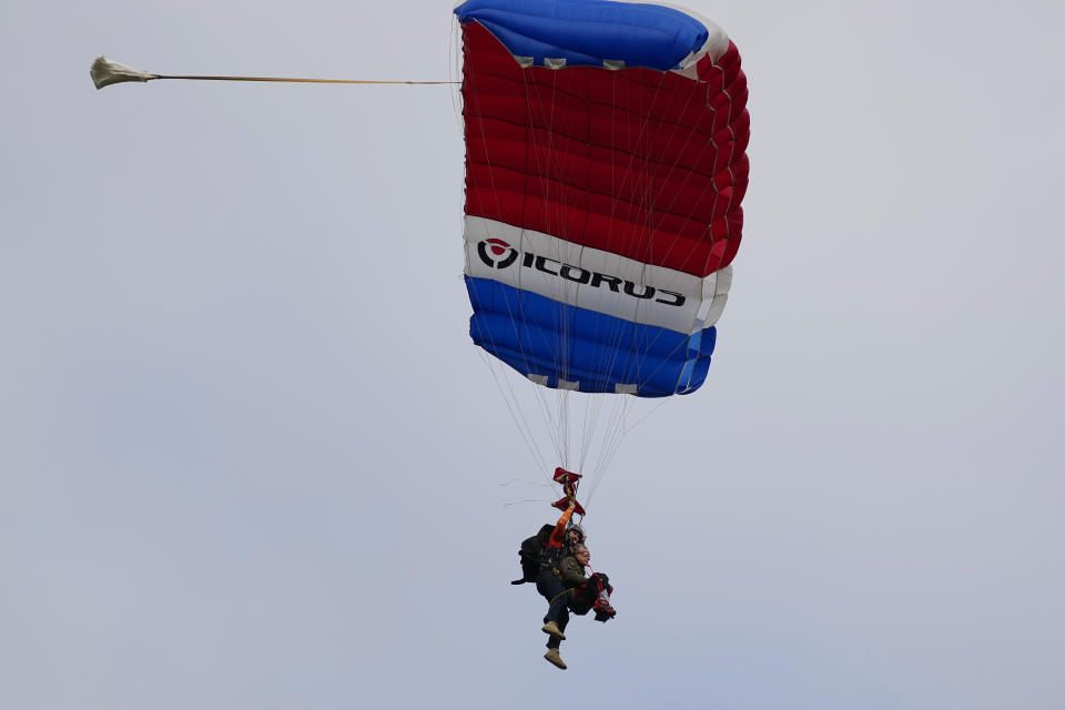 Texas Gov. Greg Abbott skydives in tandem Monday, Nov. 27, 2023, in Fentress, Texas. Abbott was invited to jump by 106-year-old World War II veteran Al Blaschke. (AP Photo/Eric Gay)