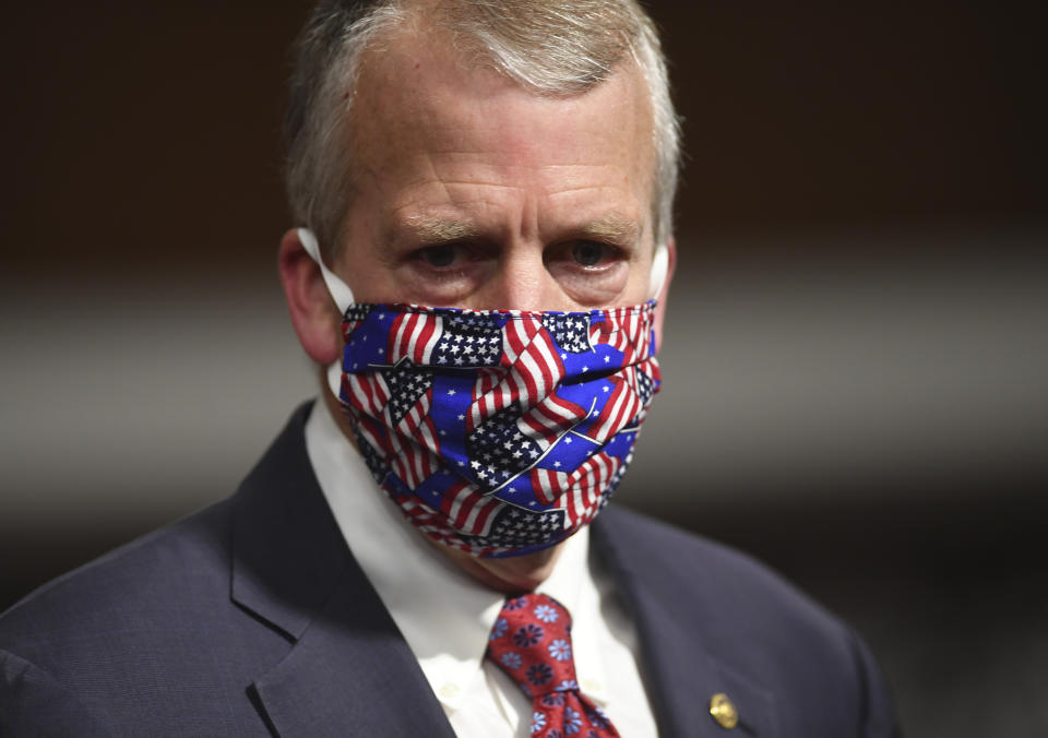Sen, Dan Sullivan, R-Ark., wears a mask at a hearing, as Kenneth Braithwaite, nominated to be Secretary of the Navy, Gen. Charles Q. Brown, Jr., nominated for reappointment to the grade of General and to Chief of Staff of the U.S. Air Force, and James Anderson, nominated to be Deputy Under Secretary of Defense for Policy testify, during a Senate Armed Services Committee hearing on Capitol Hill in Washington, Thursday, May 7, 2020. (Kevin Dietsch/Pool via AP)