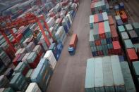 FILE PHOTO: A truck drives between shipping containers at a container terminal at Incheon port in Incheon