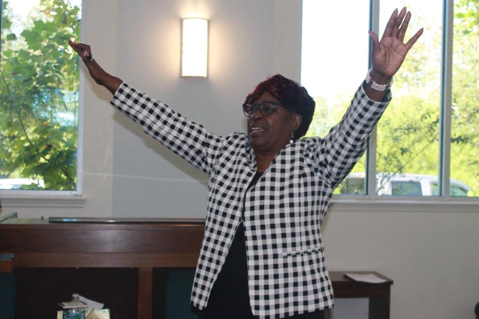 The Rev. Dr. Marie Herring, pastor of DaySpring Baptist Church, praise the Lord during a service celebrating the church's 108th anniversary.