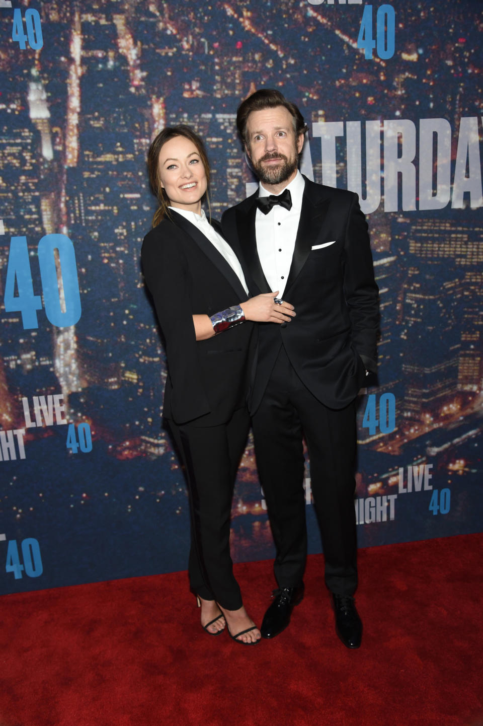 Olivia Wilde, wearing an H&M Conscious Commerce Collection suit, matches her husband, Jason Sudeikis. The couple that dresses together, stays together…