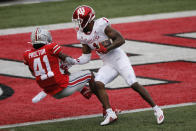 Indiana receiver Whop Philyor, right, forces his way into the end zone past Ohio State defensive back Josh Proctor during the first half of an NCAA college football game Saturday, Nov. 21, 2020, in Columbus, Ohio. (AP Photo/Jay LaPrete)