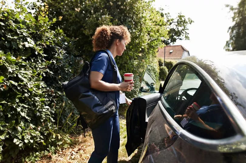 Female opening door of car in front yard