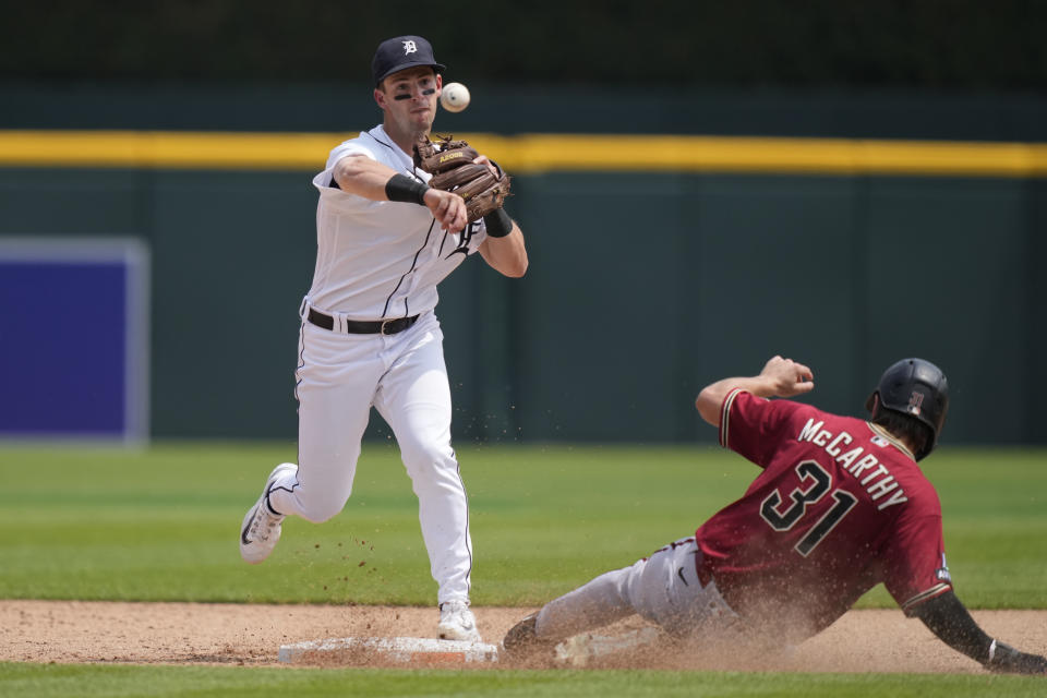 Detroit Tigers second baseman Zack Short throws to first to complete the double play hit into by Arizona Diamondbacks' Ketel Marte during the seventh inning of a baseball game, Saturday, June 10, 2023, in Detroit. (AP Photo/Carlos Osorio)