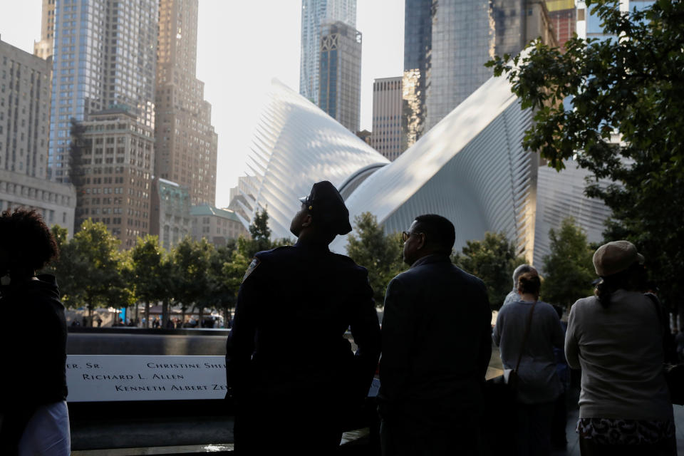 <p>People pause at the edge of the South reflecting pool at the National September 11 Memorial and Museum during ceremonies marking the 16th anniversary of the Sept. 11, 2001, attacks in New York, Sept. 11, 2017. (Photo: Brendan McDermid/Reuters) </p>