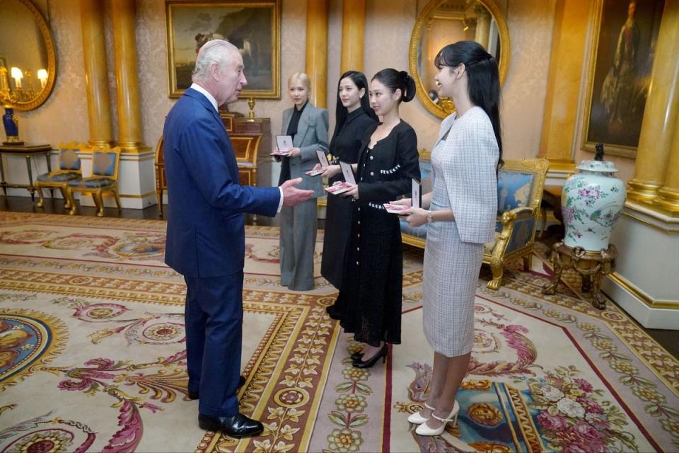 King Charles III presenting (L-R) Roseanne Park, Jisoo Kim, Jennie Kim, and Lalisa Manoban with their medals (PA)