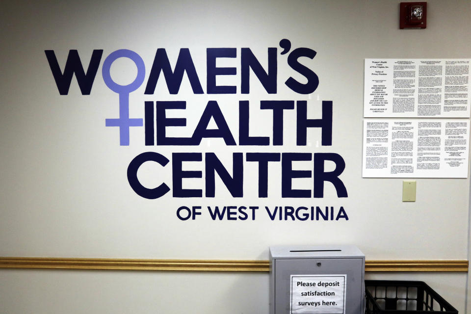 A sign for the Women's Health Center of West Virginia is displayed in the clinic's empty waiting room on Wednesday, June 29, 2022 in Charleston, W.Va. West Virginia's only abortion clinic stopped performing abortions after the U.S. Supreme Court overturned Roe v. Wade, but the facility is still open to provide routine gynecological care, like cervical exams and cancer screenings. (AP Photo/Leah Willingham)