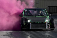 A racer spews pink smoke from his car during a "gender reveal" at Bandimere Speedway west of Denver on Wednesday, May 5, 2021. The Colorado State Patrol runs a program called "Take it to the Track" in hopes of luring racers away from public areas to a safer and more controlled environment, even allowing participants to race a trooper driving a patrol car. The program's goals have gained new importance and urgency this year as illegal street racing has increased amid the coronavirus pandemic. (AP Photo/Thomas Peipert)