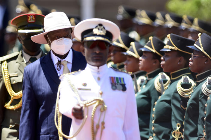 Ugandan President Yoweri Museveni, centre, wearing mask, inspects a guard of honour during a welcoming ceremony in Pretoria, South Africa, Tuesday, Feb. 28, 2023. Museveni's visit is directed at consolidating bilateral relations between the two countries, with discussions between the two Heads of State encompassing political, economic, regional, continental and international issues. (AP Photo)