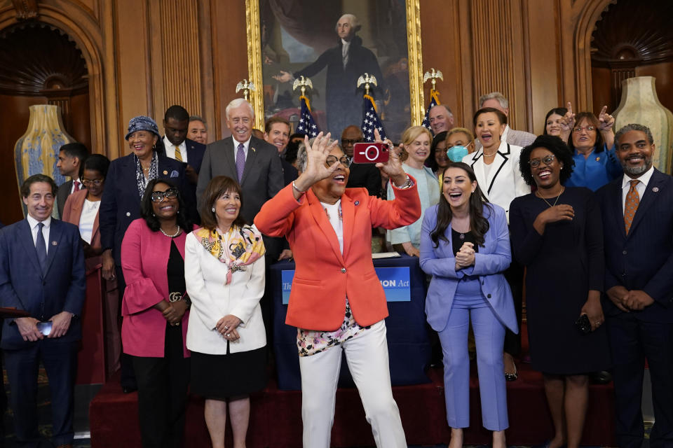 Rep. Joyce Beatty, D-Ohio, center, takes a photo before the start of a bill enrollment ceremony with House Speaker Nancy Pelosi of Calif., for the Inflation Reduction Act of 2022 on Capitol Hill in Washington, Friday, Aug. 12, 2022. (AP Photo/Susan Walsh)